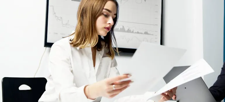 A woman comparing two papers