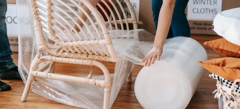 A person wrapping a chair