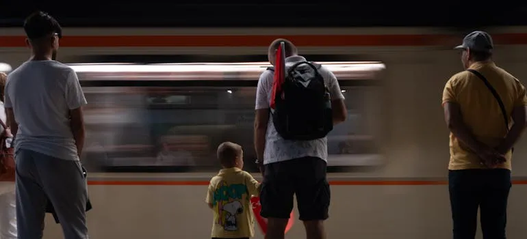 A father and a son waiting for a train
