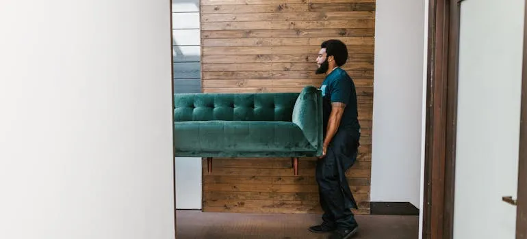 A mover carrying sofa