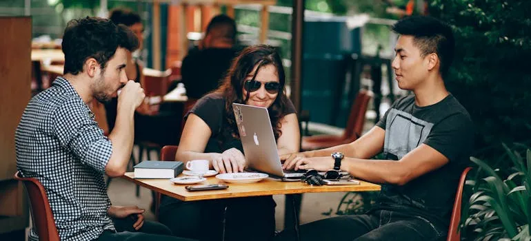 Three people working in one of the remote work-friendly cities in Virginia