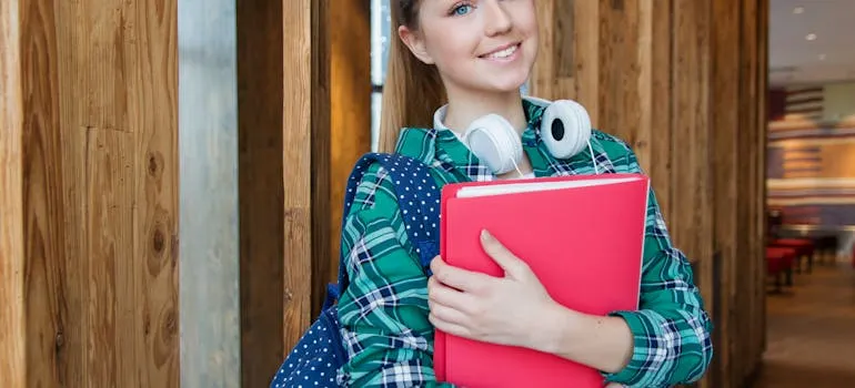 A girl holding books