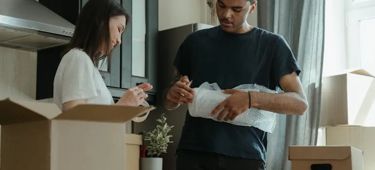 A couple packing by using a guide to relocating to Gaithersburg
