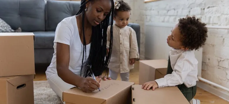 A woman with the kids packing for relocation