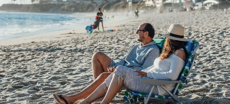 A couple on the beach talking about why Marylanders are moving to California