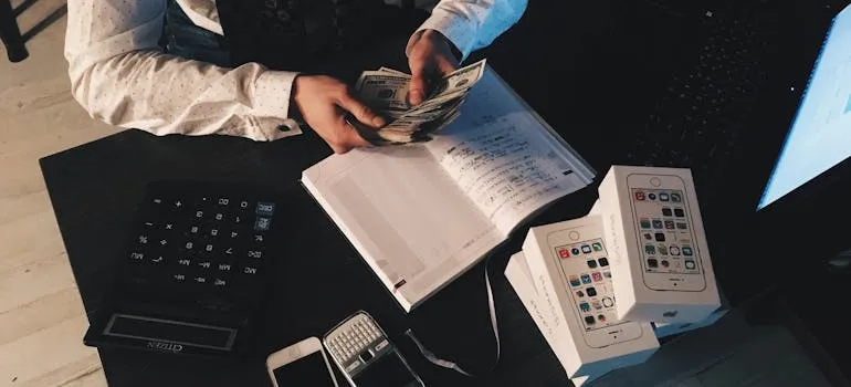 A person making a moving budget by using a checklist for moving from DC to Florida