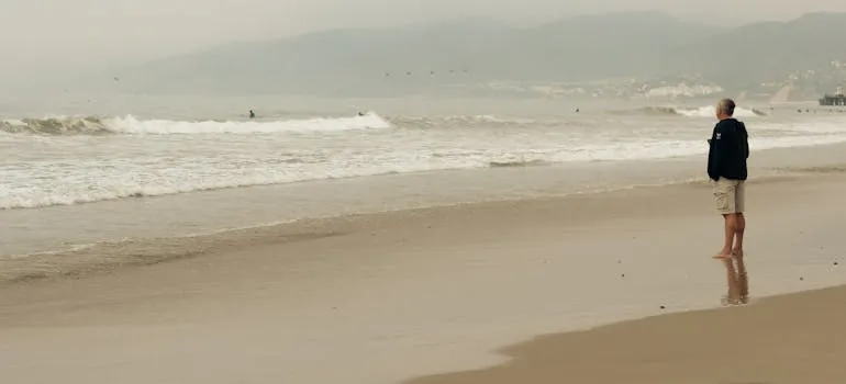 A person on the beach thinking about the reasons to move from Maryland to Delaware