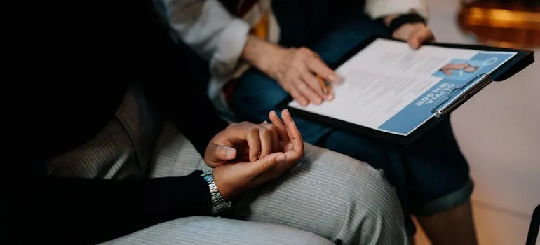 A person holding CV to use it for job opportunities in Rockville