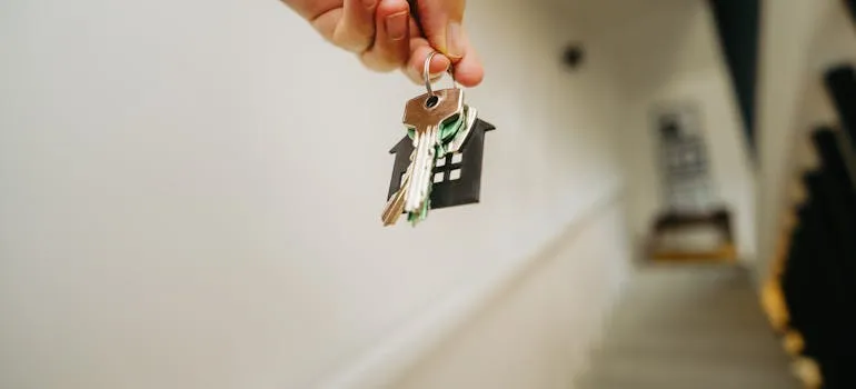 A person holding a house key