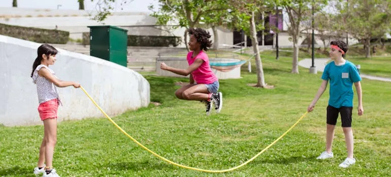 Kids in the park using one of the amenities for Arlington newcomers