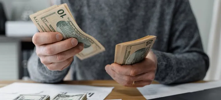 A person counting dollar bills
