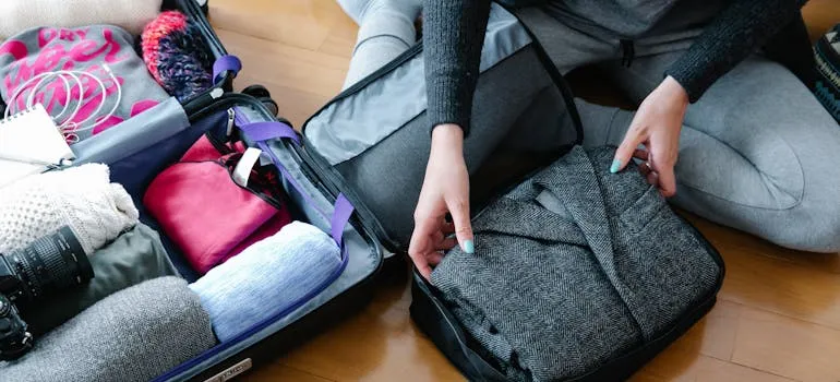 A person packing essential items by following the checklist for relocating from Maryland to North Carolina