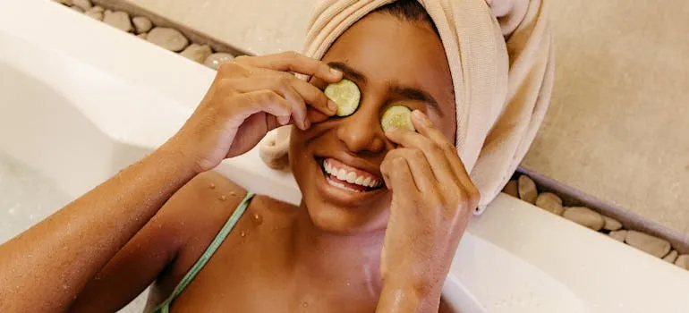 A woman with cucumber on her eyes enjoying wellness retreats in Maryland
