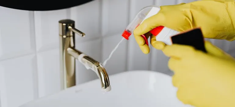 A person cleaning a bathroom