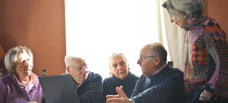 Seniors using laptop to find a guide to moving to Northern Virginia