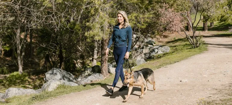 A woman in the park with the dog