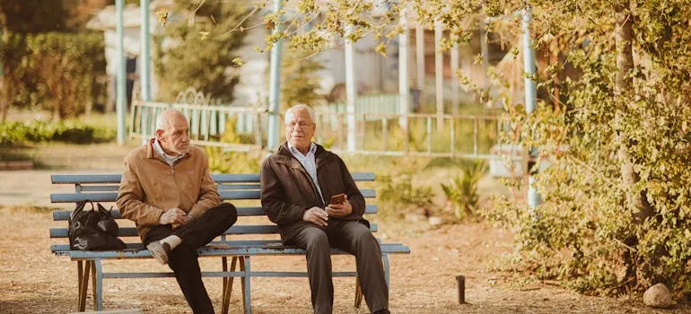 Two seniors on the bench talking about why Austin is an ideal destination for retirees
