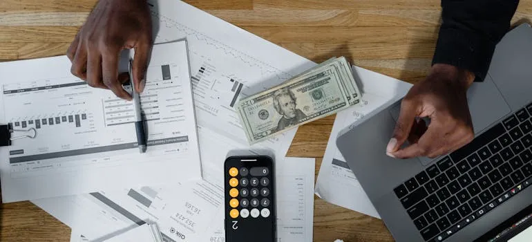 Dollar bills next to the calculator