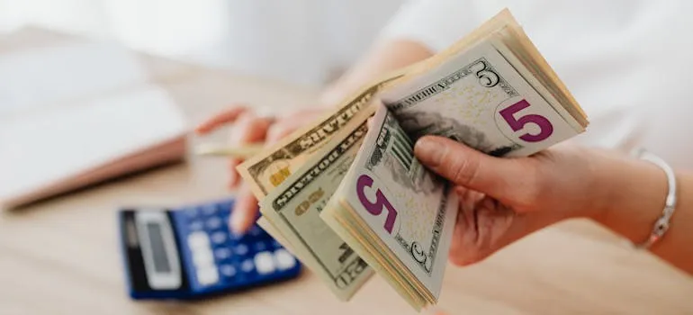 A person holding dollar bills