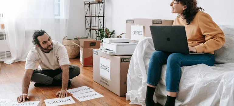 A couple using a laptop to find Frederick County movers
