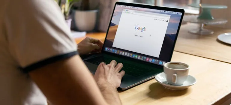 A person using laptop for hiring a piano mover
