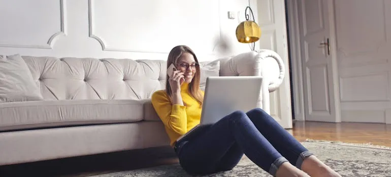 A woman talking on the phone in the house
