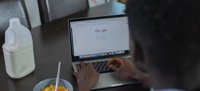 A person using a laptop to find out why is May the designated National Moving Month