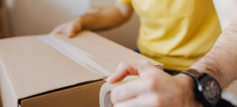 A person packing a moving box