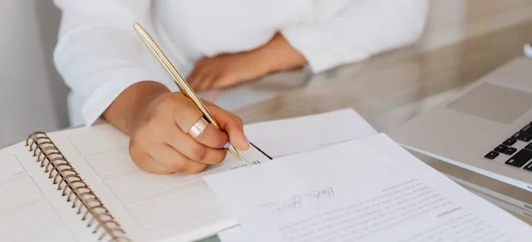A person writing on the paper