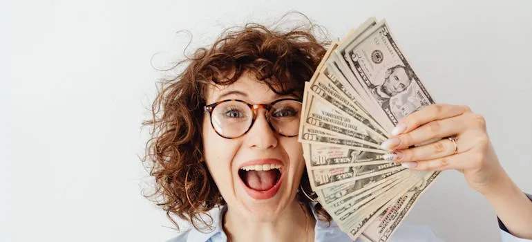 A person holding dollar bills 