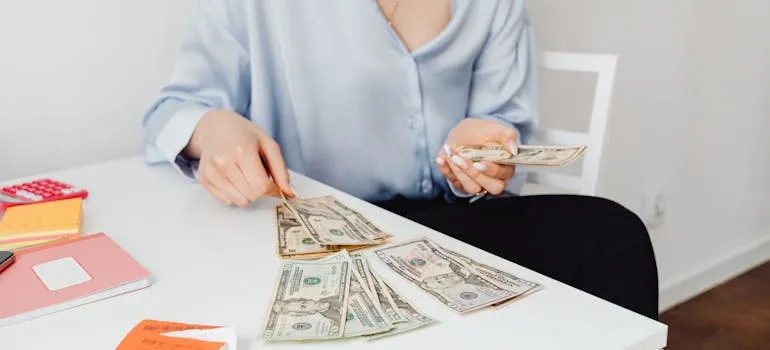 A person counting dollar bills