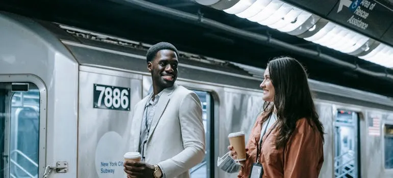 Two people in front of the train talking about Gaithersburg neighborhood breakdown