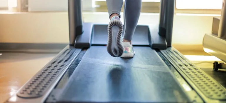 A person using a treadmill and thinking how to relocate unique and valuable items interstate