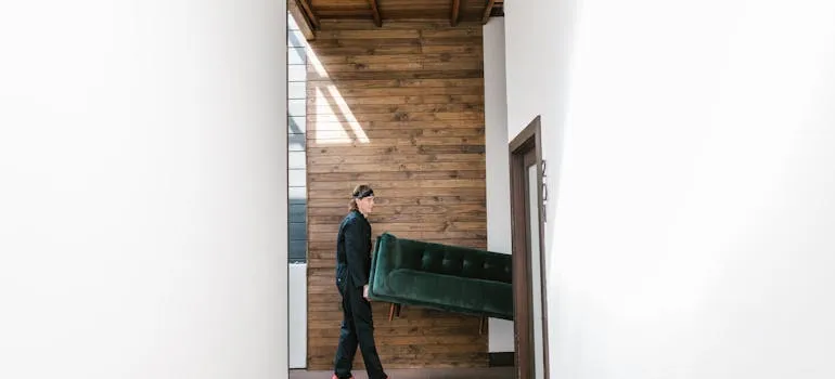 A mover holding a sofa