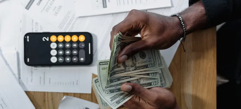 A person calculating the cost of moving your family from DC to California