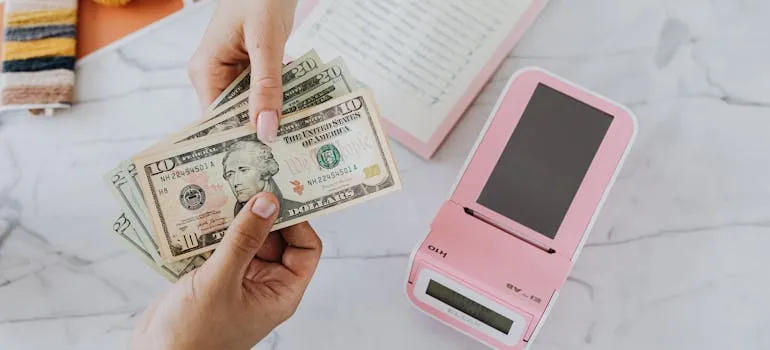 A person buying property in Pennsylvania with dollar bills