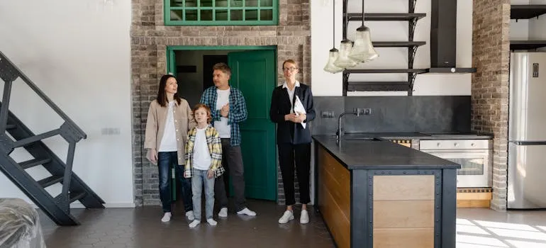 A family talking with the real estate agent about raising a family in Maryland vs Delaware
