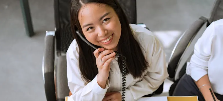 A woman talking on the phone with movers Jessup MD