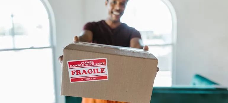 One of the movers Mt Airy holding a moving box