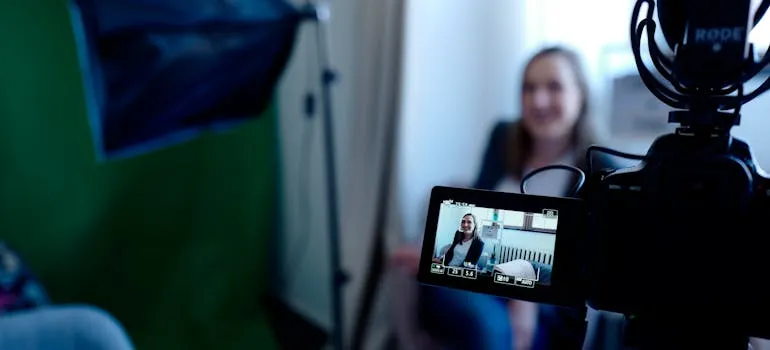 A person filming video to announce your relocation from Rockville