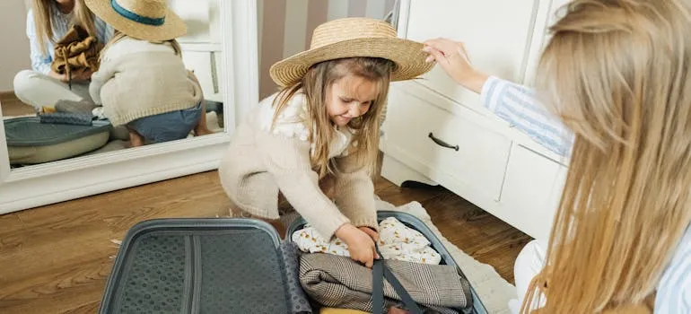 A kid and a mother packing