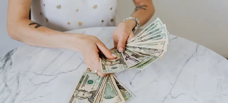 A person counting dollar bills