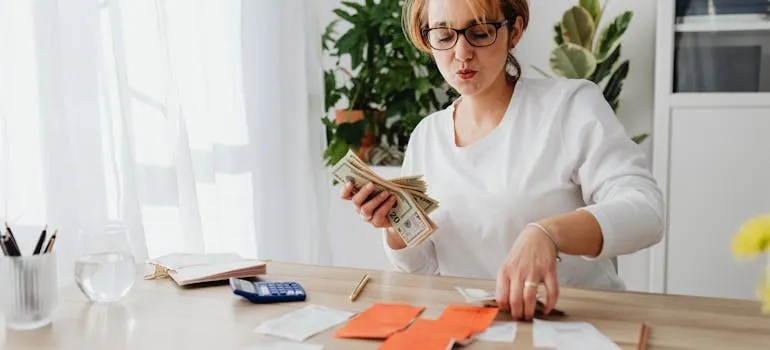 A woman counting dollar bills