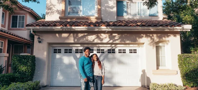 A couple in front of the house in one of the North Carolina cities for former Maryland residents