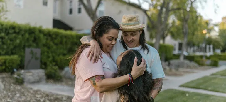 Three women hugging and talking about the emotional side of moving in the DMV