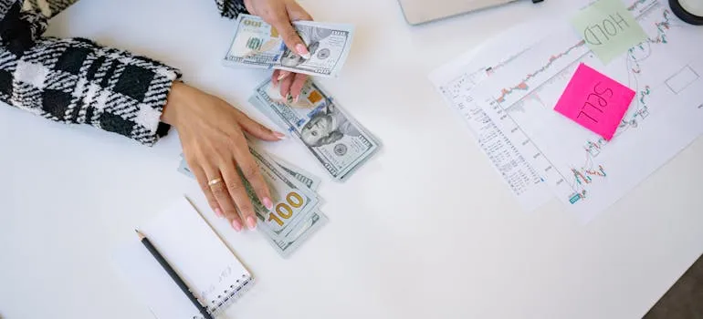A person counting dollar bills