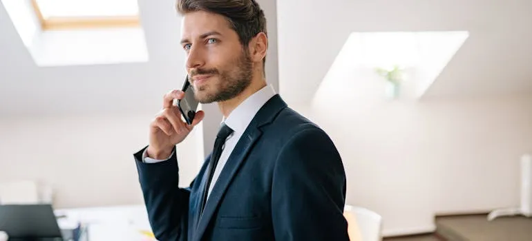A man in the suit talking on the phone