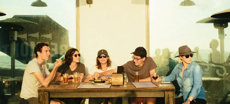 Friends in the restaurant talking about moving from Washington DC to Arlington