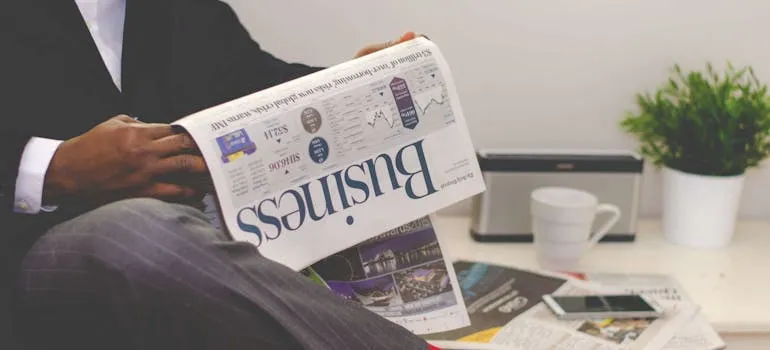 A man holding newspapers