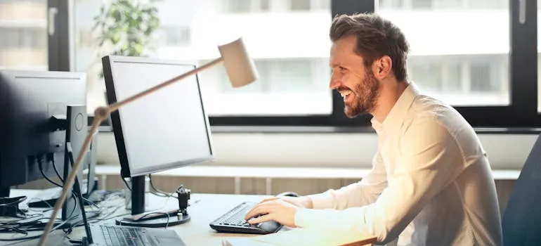 A man in the office researching on the laptop should you move out of DC